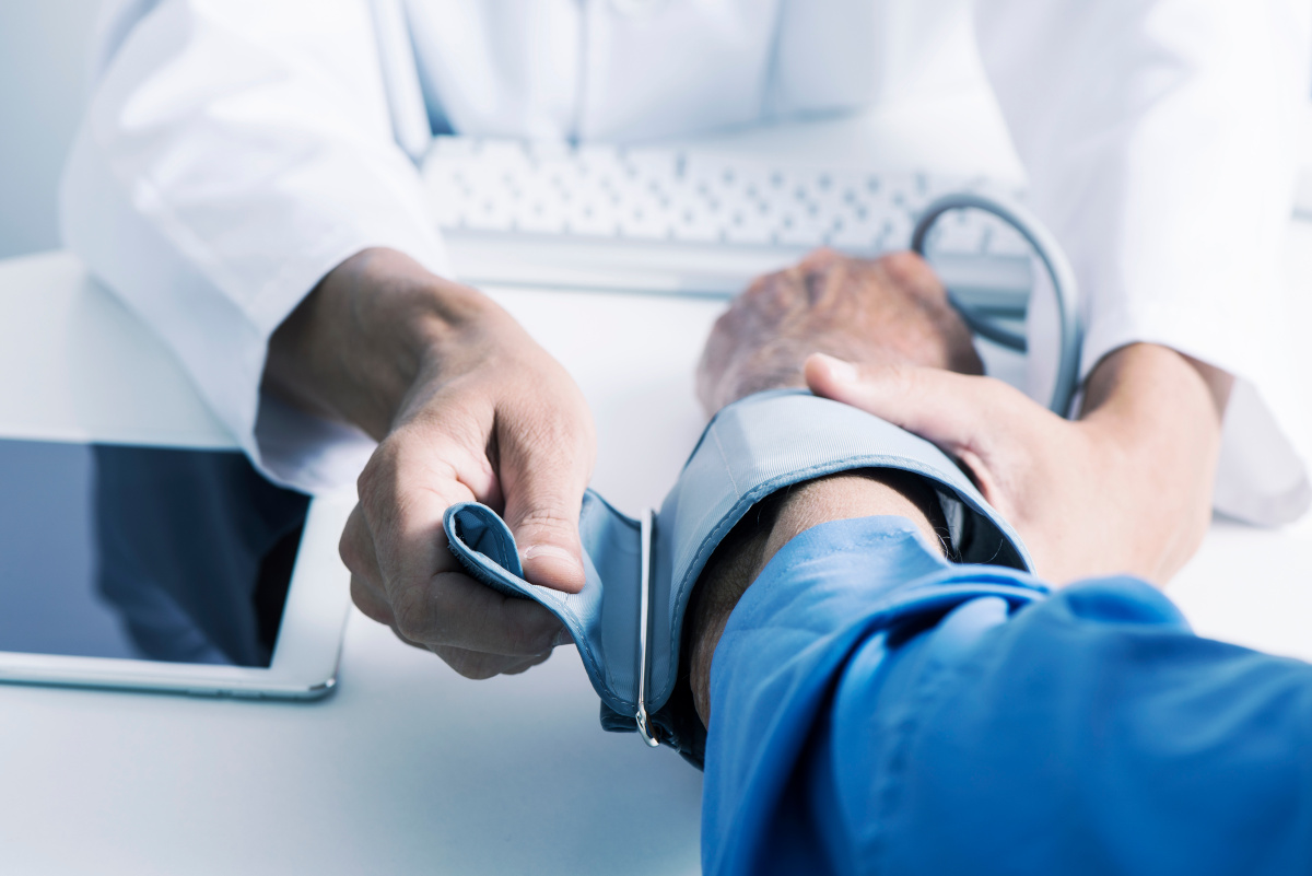 Medical Professional Using Blood Pressure Cuff on Patient